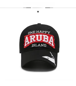 Detailed close-up of white shark embroidery and Aruba island patch on a black baseball cap