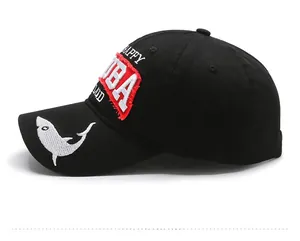 Side view of black washed baseball cap featuring Cuba patch and shark embroidery details
