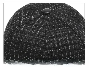 Close-up of the meticulous stitching on a black and white tweed baseball cap crown