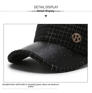 Detail of black tweed baseball cap with embossed leather brim and golden metal R logo