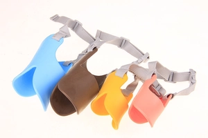 Silicone duckbill muzzles in blue, brown, yellow, and pink with adjustable nylon straps