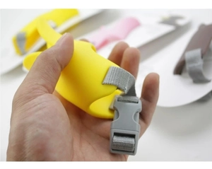 Detail of yellow duck muzzle for dogs with adjustable grey nylon strap and buckle