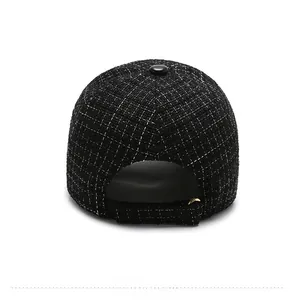 Detailed back view of a black tweed baseball cap with adjustable metal buckle strap