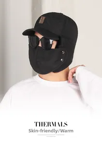 Detail of black winter trapper hat with quilted design and detachable face mask