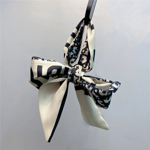 Detail of blue and white oblique pattern silk hair tie with elegant bow knot design