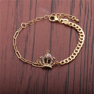 Detail of gold crown bracelet with colorful cubic zirconia on a rustic wooden background