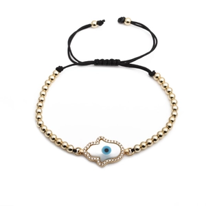 Adjustable black cord Hamsa hand bracelet with gold beads and blue evil eye charm