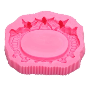 Pink silicone mold featuring intricate European scrollwork and relief for cake decorating