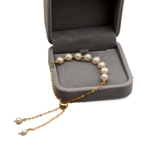 Minimalist freshwater pearl bracelet with adjustable 14k gold-plated chain on jewelry box