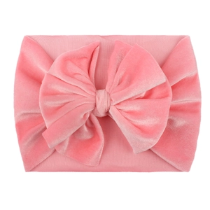 Soft pink velvet bow headband for infants on a clean white background, fashion hair accessory