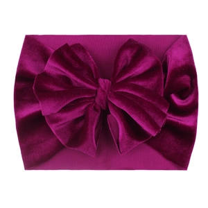Detailed view of magenta velvet baby headband with a soft large decorative bow