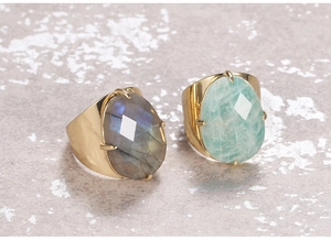 Close-up of adjustable gold rings with faceted labradorite and amazonite gemstones