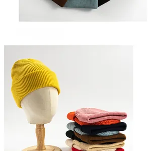 Close-up of colorful ribbed knit beanies stacked neatly in various vibrant colors