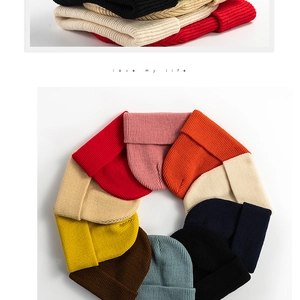 Detailed view of colorful knitted beanies in various shades with love my life text