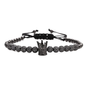 Adjustable woven bracelet featuring black beads and a pave zircon crown charm