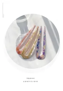 Close-up of three acetate U-shaped hair pins with elegant marble textures and soft shadows