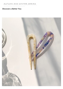 Detail of U-shaped acetate hair pins in beige marble and purple nebula patterns