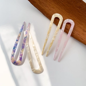 Elegant U-shaped acetate hair pins in marble and floral patterns for modern hair styling