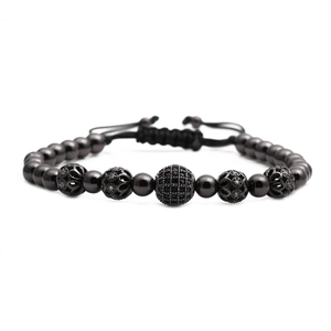Adjustable black bead bracelet featuring micro-pave zircon ball and woven cord