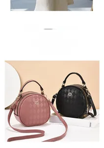 Detailed view of round quilted crossbody bag with metal logo and dual zipper closures