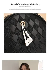 Detail of crossbody bag with functional headphone port and quilted leather texture