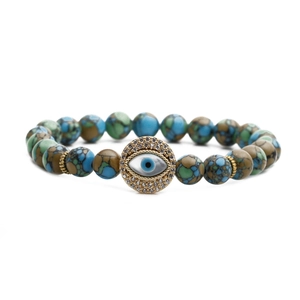 Macro detail of natural stone beads and Evil Eye pendant with zircon inlay on bracelet