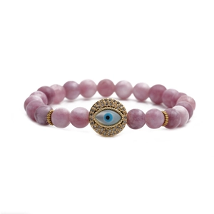 Macro detail of 8mm purple stone beads and a gold-plated evil eye charm on the bracelet