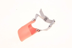 Detail of pink silicone duck muzzle for dogs with grey adjustable nylon strap and buckle