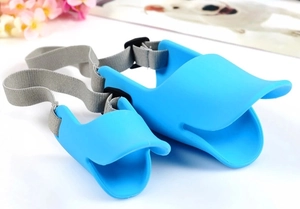 Detailed view of blue silicone duck muzzle for dogs in large and small sizes on white desk