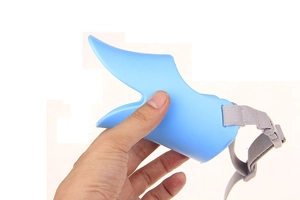Detail view of light blue silicone duckbill dog muzzle with adjustable nylon strap