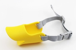 Detail of yellow duckbill muzzle with grey nylon strap and adjustable buckle for dogs