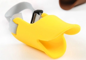 Detail of yellow silicone duck-bill muzzle with gray adjustable nylon strap and buckle