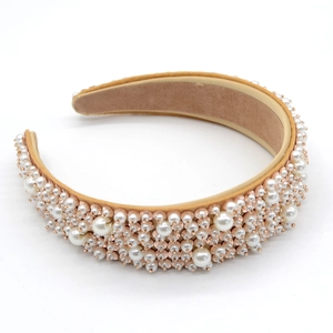 Macro view of wide champagne headband featuring clustered white pearls and beads