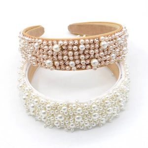 Detailed view of wide baroque headbands with pearls in white and champagne gold colors