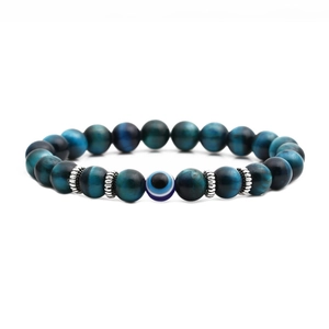 8mm blue tiger eye bead bracelet with silver spacers and central evil eye charm on white background