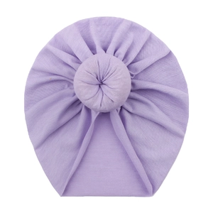 Detail of soft purple baby donut turban hat with a circular knot and ribbed texture