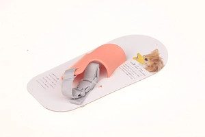 Close-up of pink silicone duckbill dog muzzle on Japanese retail packaging card