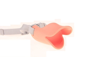 Detailed view of pink silicone duck-billed muzzle with adjustable gray nylon strap