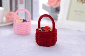 Detailed macro view of velvet basket jewelry boxes with delicate ribbon flower accents
