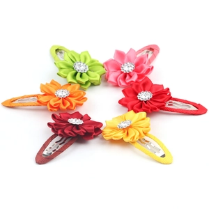 Macro detail of six-color fabric flower hair clips with rhinestones for kids