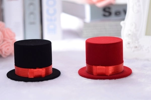 Close-up of mini red and black flocking hat hair accessories with ribbon bows
