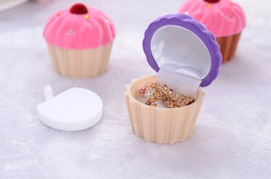 Macro detail of cupcake-shaped jewelry box showing soft velvet texture and interior space
