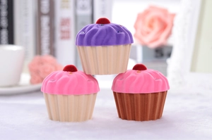 Macro shot of cupcake-shaped velvet jewelry boxes with soft colorful flocking texture