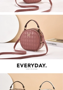 Detail of round quilted leather crossbody bag with metal logo and dual zippers
