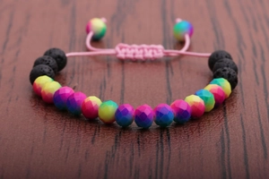 Detailed macro view of multifaceted colored beads and lava stones on an adjustable cord