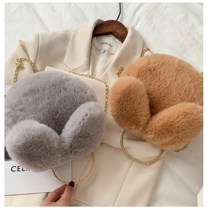 Detailed view of grey and brown plush faux fur handbags with gold chain and metal handles