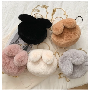 Close-up of fluffy plush rabbit ear bags with gold chains and metal handles in five colors