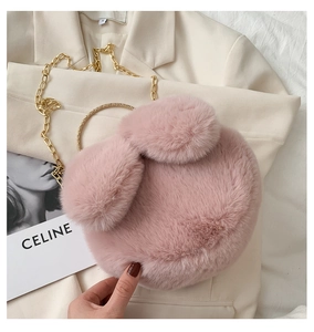 Detailed close-up of pink faux fur rabbit ear bag with gold metal handle and chain strap