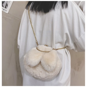 Plush bunny ear crossbody bag with gold chain strap shown on model's back view