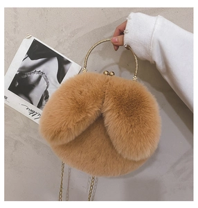 Detailed view of plush rabbit ear bag with vintage metal handle and golden chain strap